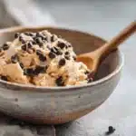 Chickpea cookie dough served in a ceramic bowl with chocolate chips
