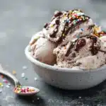 Ninja Creami protein ice cream in a glass pint on a kitchen counter