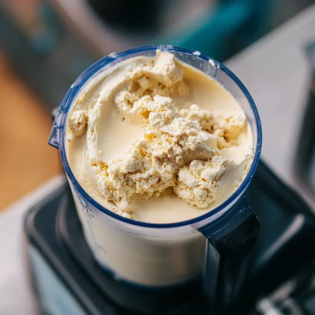 Ninja Creami protein ice cream in a glass pint on a kitchen counter