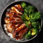 Honey garlic chicken thighs served atop jasmine rice with broccoli