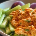 High protein buffalo chicken salad with fresh ingredients in a bowl