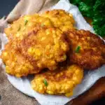 Golden brown easy old-fashioned corn fritters served on a plate