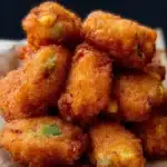 Plate of homemade jalapeno corn nuggets served with dipping sauce.