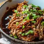 Irresistibly Juicy Slow Cooker Asian Pulled Pork Delight 33 Juicy Asian pulled pork cooked in a slow cooker, served with fresh vegetables.