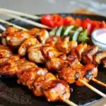 BBQ Chicken Kebabs 8 Grilled BBQ chicken kebabs on skewers with colorful vegetables