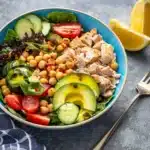 Crispy Chickpea Tuna Salad 12 Crispy chickpea tuna salad served in a bowl with fresh vegetables and herbs.