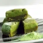 Matcha Brownie Mochi Brochi 9 Delicious matcha brownie mochi brochi with a green tea coating and chocolate drizzle.