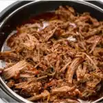 Slow Cooker BBQ Pulled Pork 7 Delicious Slow Cooker BBQ Pulled Pork served on a bun with coleslaw