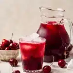 Cherry Pie Inspired Iced Tea 11 Cherry Pie Inspired Iced Tea served in a glass with cherries and pie slice